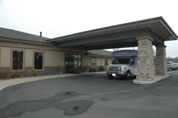 Exterior view of the facility entrance with transport vehicle