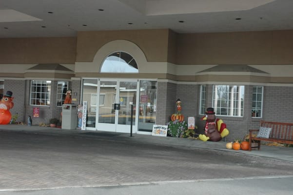 Exterior view of facility entrance decorated for fall