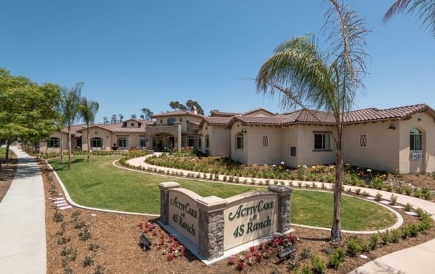 Exterior view of a nursing home facility with landscape