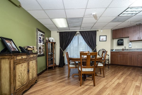 Warmly decorated dining area with a table and chairs