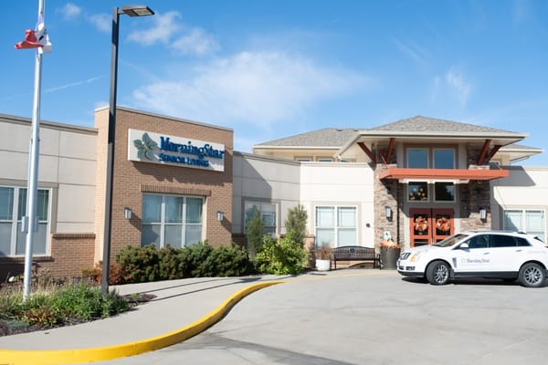 Exterior view of MorningStar Assisted Living facility with logo