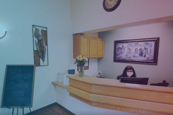 Reception area with staff member behind the desk