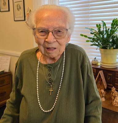 Senior resident posing with a warm smile indoors