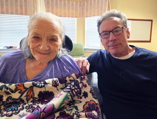 Resident and visitor sharing a moment indoors