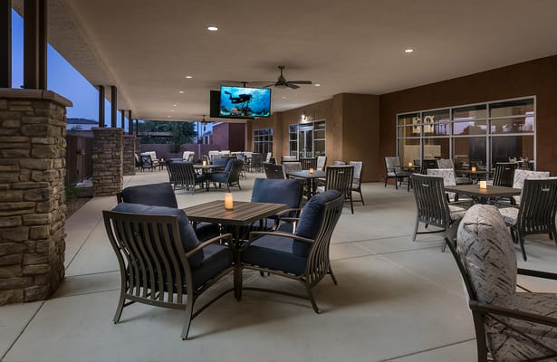 Outdoor patio area with seating and television