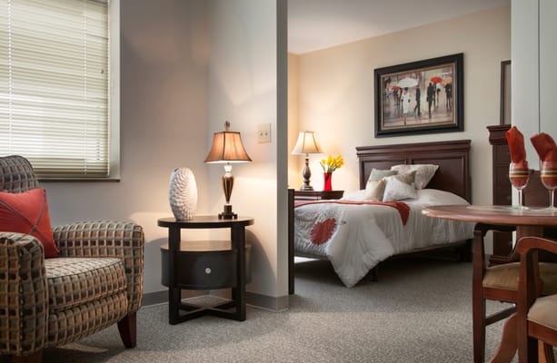 Cozy resident room with a bed and seating area