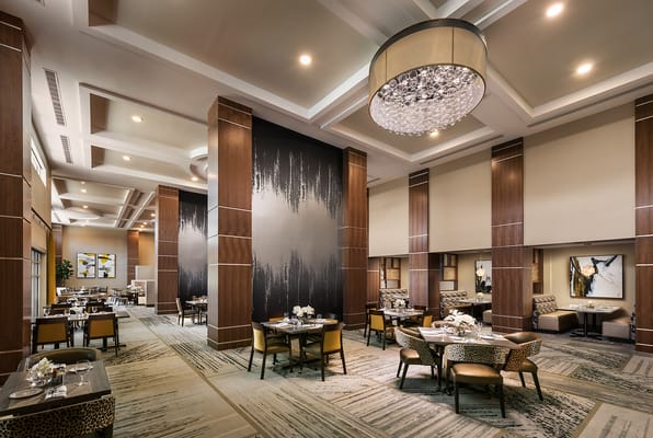 Elegant dining room setup with tables and chandeliers