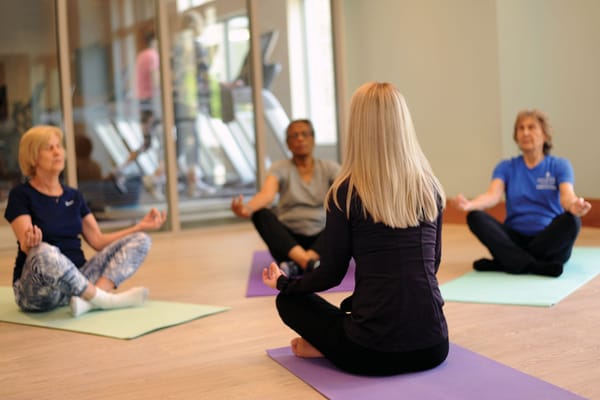 Residents participating in a yoga class indoors