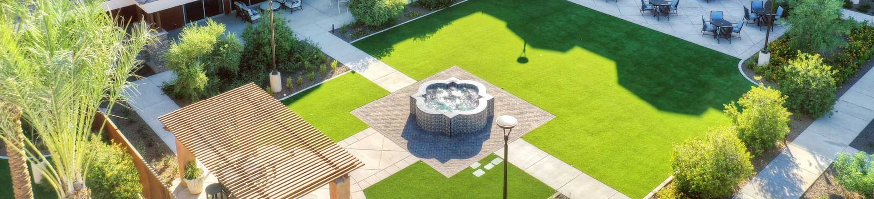 Aerial view of a landscaped outdoor space with a fountain