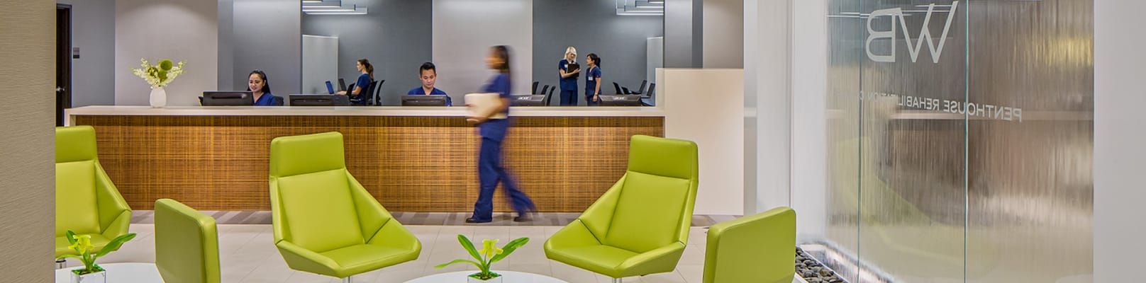 Bright reception area with staff and modern seating