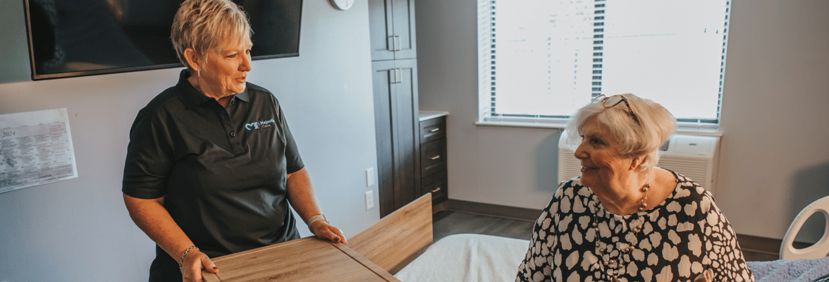 Staff member interacting with a resident in their room