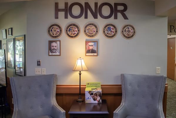 Cozy common area with two chairs and decor honoring veterans