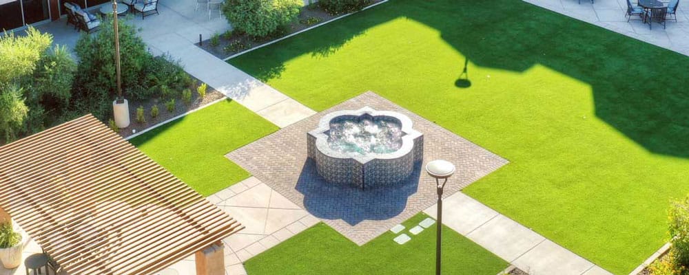 Aerial view of a landscaped outdoor space with a fountain