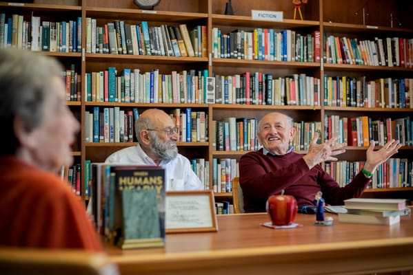 Residents engaged in conversation in a library
