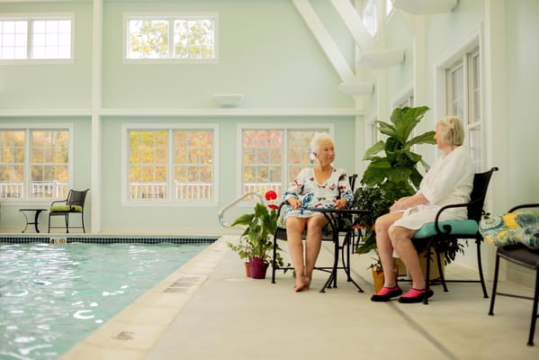 Residents relaxing by the indoor pool area