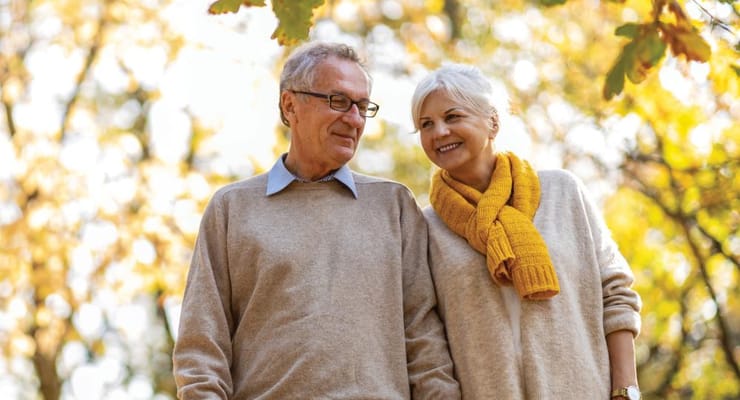 Couple walking together in an autumn park