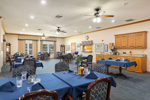 Dining room with blue table settings and wooden furniture