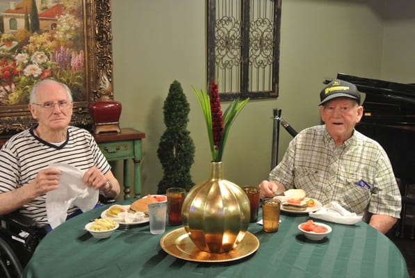 Two residents enjoying lunch in a dining area