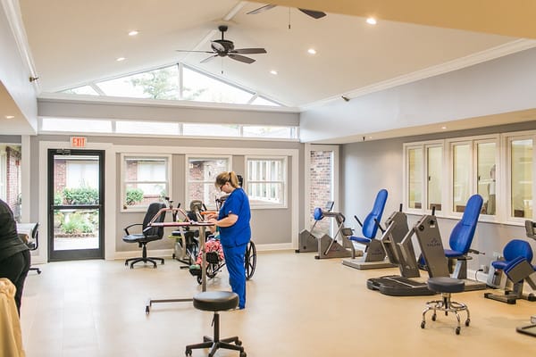 Interior view of a therapy room with staff and equipment