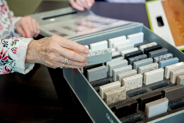 A resident selecting materials from a sample box