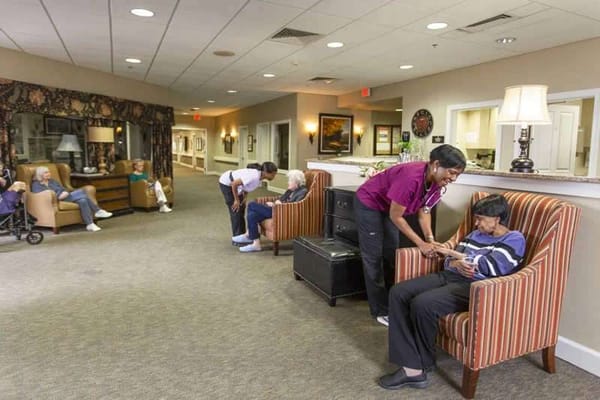 Staff member assisting a resident in a common area