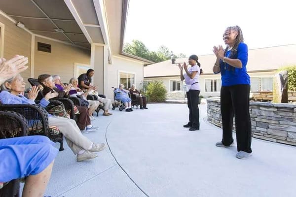 Residents enjoying outdoor activities with staff
