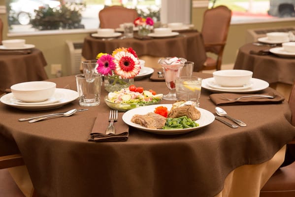 Plated meal with salad and dessert at a dining table