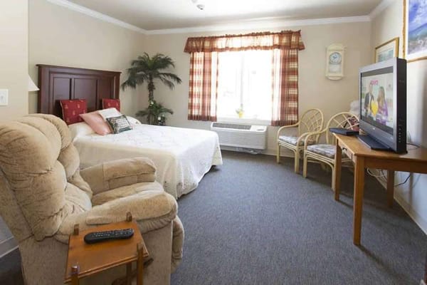 Cozy resident room with a bed and seating area