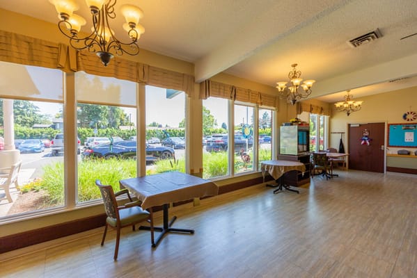 Common area with tables and large windows
