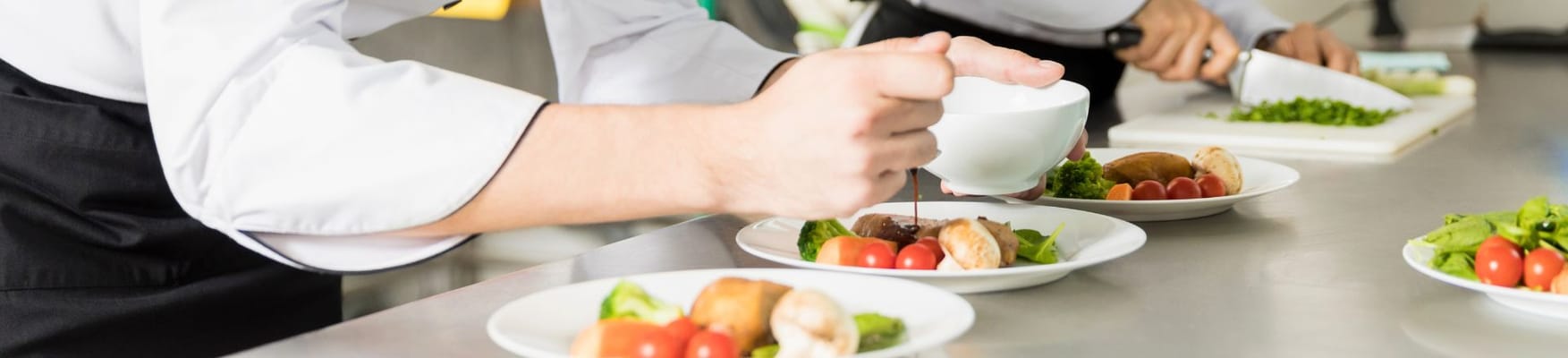 Chef plating meals in the kitchen