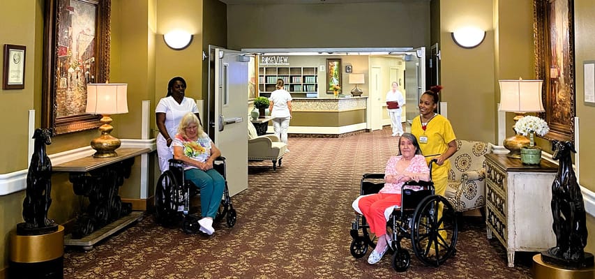 Residents and staff interacting in a well-lit common area
