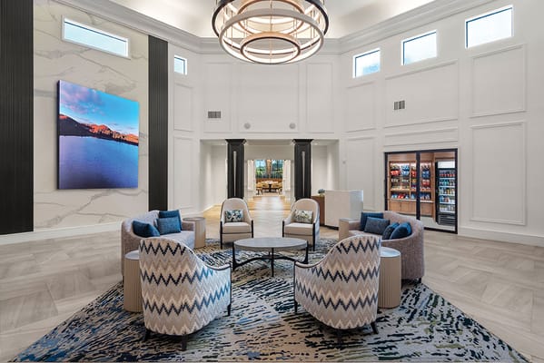 Bright common area with seating and a large artwork