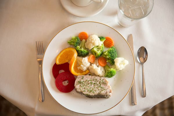A plate of nutritious food with vegetables and fish