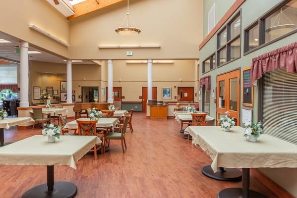 Bright dining area with tables and flowers