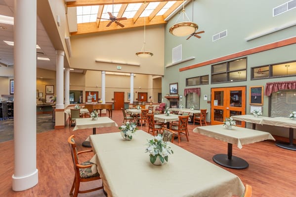 Bright dining area with tables and floral centerpieces