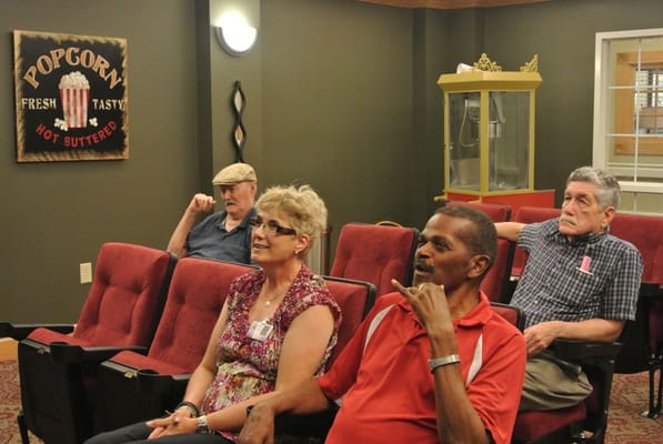 Residents enjoying a movie in a common area