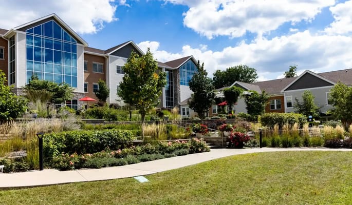 Exterior view of Cottage Grove Place with gardens and landscaping