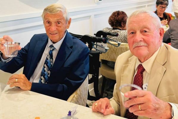Two residents raising glasses in a celebratory toast