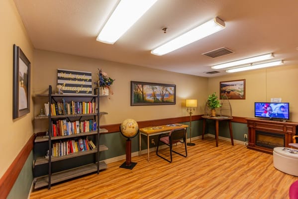 Interior view of a common area with bookshelves and seating