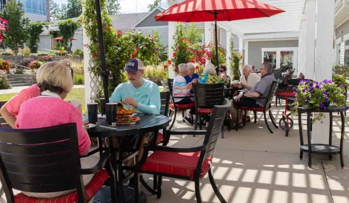 Residents enjoying an outdoor meal at tables