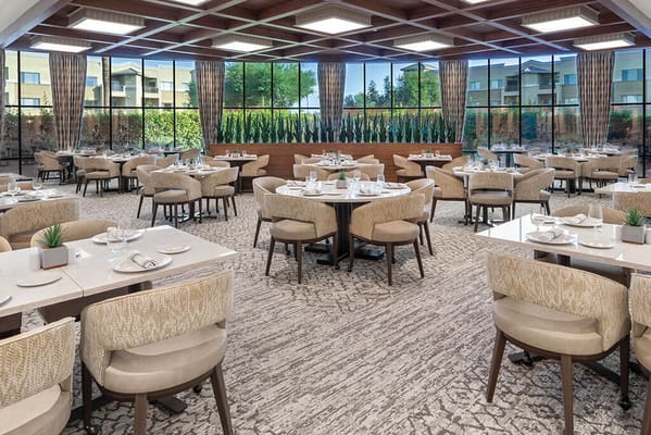 Elegant dining room with circular tables and large windows