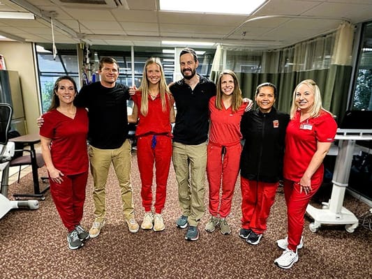 Staff members posing in the facility's therapy room