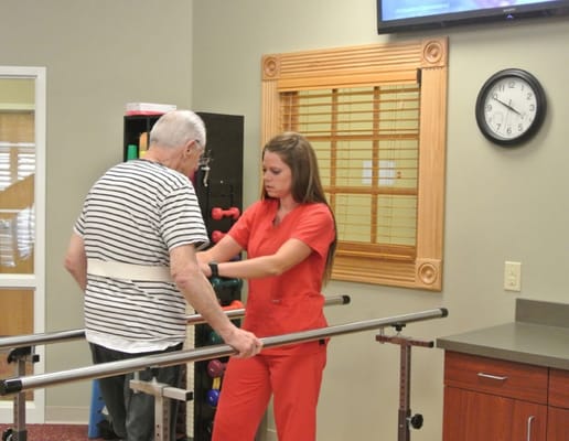 Therapist assisting a resident with rehabilitation exercises