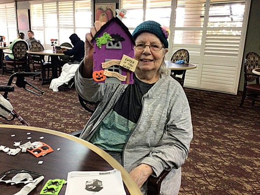 Resident participating in a craft activity indoors