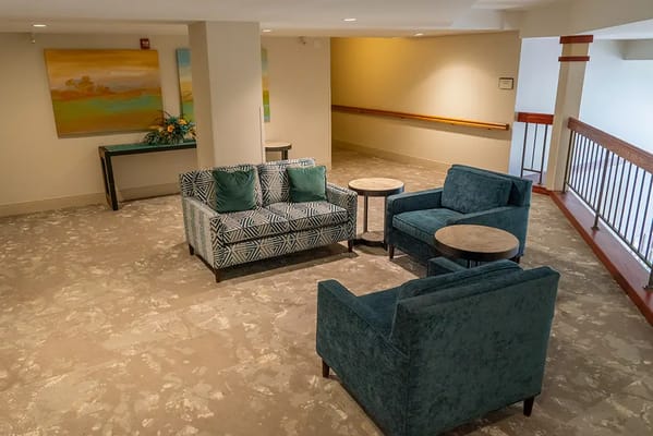 A cozy common area with seating and art