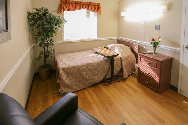 Cozy resident room with bed and furniture