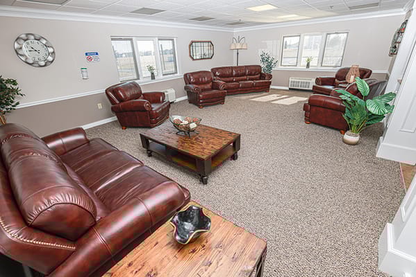 Common area with leather seating and natural light
