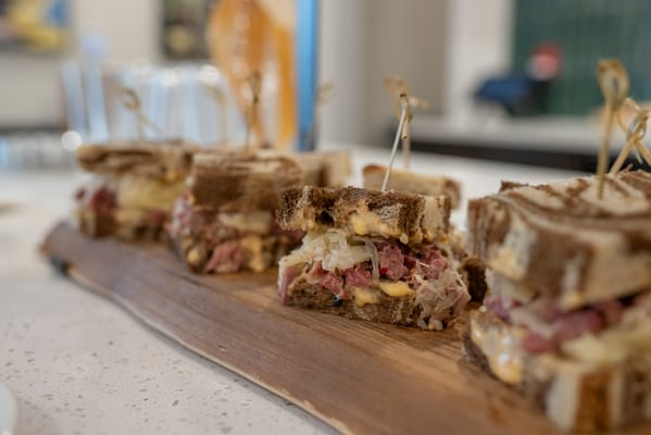 Meal featuring sandwiches on a wooden platter