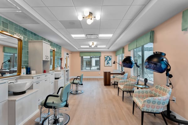 A bright salon area with styling chairs and mirrors