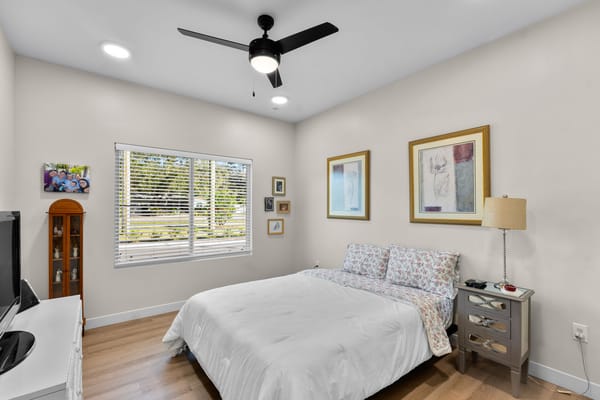 Bright bedroom with a double bed and wall art